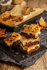 Delicious pumpkin cake with cheese cream and cacao or chocolate on the top