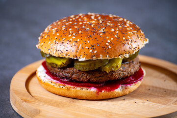 Lunch or dinner with tasty vegetarian hamburgers made from plant based grilled burgers, fresh bakes buns and organic vegetables