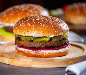 Lunch or dinner with tasty vegetarian hamburgers made from plant based grilled burgers, fresh bakes buns and organic vegetables