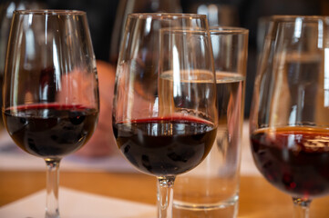 Professional tasting of different fortified dessert ruby, tawny port wines in glasses in porto cellars in Vila Nova de Gaia, Portugal