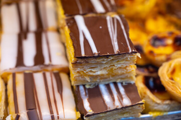 Traditional dessert pastry in Portugal, puff eggs cream cakes with chocolate