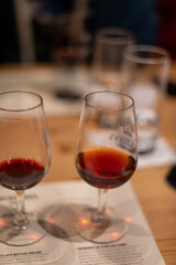 Professional tasting of different fortified dessert ruby, tawny port wines in glasses in porto cellars in Vila Nova de Gaia, Portugal