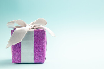 front view cute little present tied with bow on blue background gift color new year christmas photo free place