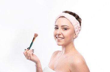 Beauty portrait of a young attractive half naked woman with brush and perfect skin posing and...