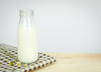 Bottles with fresh milk on a wooden table..Raw milk is high in calcium and protein to drink for all ages..Milk consumption nutritious and healthy dairy products concept.