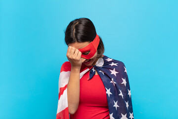 young latin woman laughing and slapping forehead like saying d’oh! I forgot or that was a stupid...