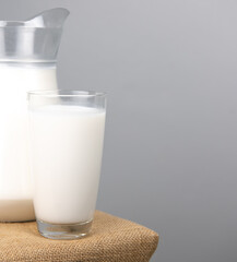 A jug of fresh milk glass on sackcloth for a background..Raw milk is high in calcium and protein to drink for all ages..Milk consumption nutritious and healthy dairy products concept.