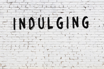 White wall with black paint inscription indulging on it