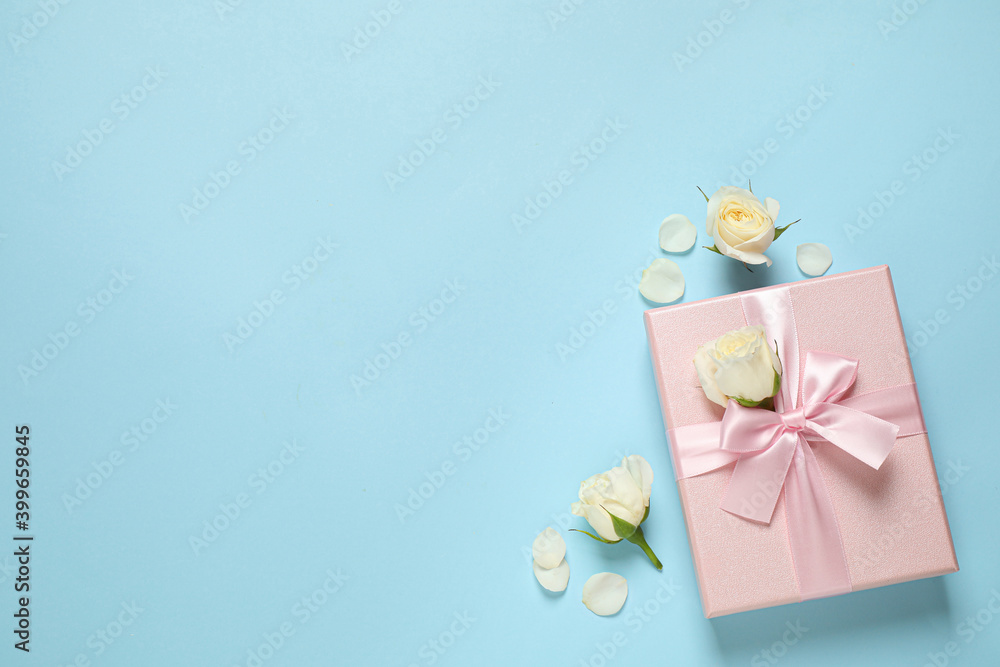 Canvas Prints Pink gift box and beautiful flowers on light blue background, flat lay. Space for text