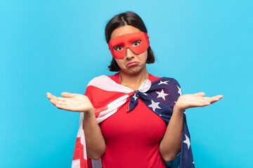 young latin woman feeling puzzled and confused, unsure about the correct answer or decision, trying...