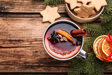 Flat lay composition with aromatic mulled wine on wooden table, space for text