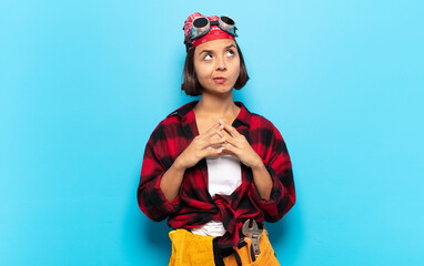 young latin woman scheming and conspiring, thinking devious tricks and cheats, cunning and betraying