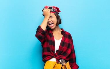 young latin woman raising palm to forehead thinking oops, after making a stupid mistake or...