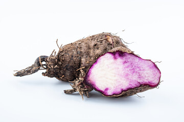 Fresh purple sweet potato on white background