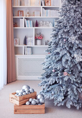 crates full of silver christmas ornaments are ready to be hanged on the christmas tree. cozy home interior