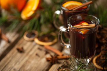 Appetizing christmas composition glasses of mulled wine on spruce cone and branch background. fragrant spices. Festive mood. Hot alcoholic drinks. View from above.