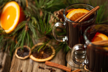 Macro shot view of appetizing christmas composition glasses of mulled wine on spruce cone and branch background. fragrant spices. Festive mood. Hot alcoholic drinks. View from above.