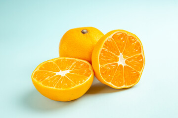 front view fresh tangerine slices on light-blue background fruit color orange juice citrus