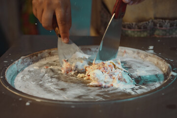 Process of making fried ice-cream dessert in night market. Thai famous gourmet street dessert food. Street food in Thailand.