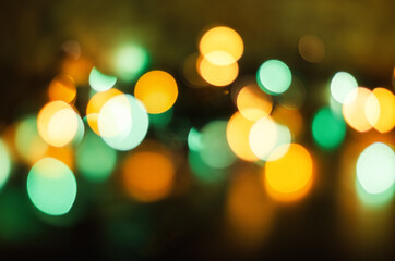 Christmas garland with colorful light bulbs in blur