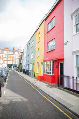 Row of colorful British houses with handrails and plants