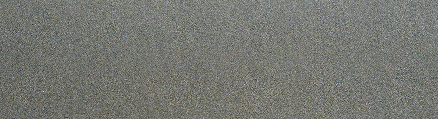 Smooth wet sand in shades of gray as a nature background
