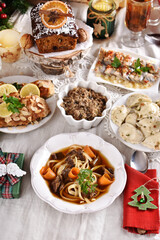 Christmas Eve supper with traditional dishes on festive table