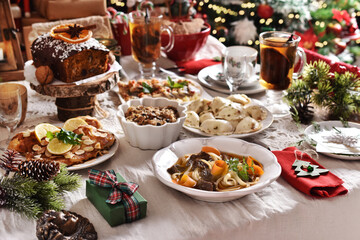 Christmas Eve supper with traditional dishes on festive table