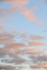 Peaceful pastel light in an evening sky, blue sky and fluffy clouds as a nature background
