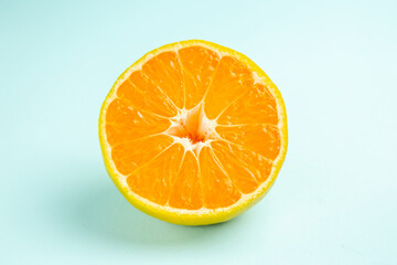 front view fresh tangerine slice on light-blue background photo orange color citrus fruit