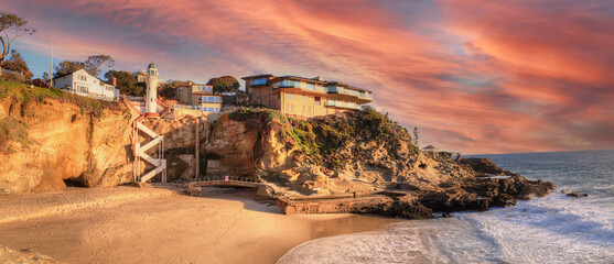 Sunset over the cliffside of One Thousand Steps beach at the ocean's edge