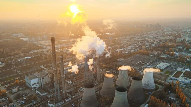 Power station with a lot of tubes and facilities in Bucharest at sunset, a lot of foam. Cityscape, view from the drone, Romania