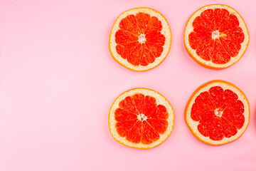 top view tasty grapefruits sliced juicy fruits lined on pink background juice fresh fruit color citrus diet free space