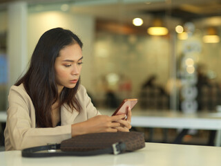 Side view of businesswoman using smartphone