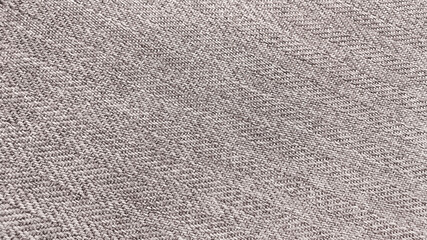 the texture of the herringbone pattern fabric. beige knit fabric with geometric patterns of wool and cotton.