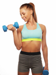 Young Woman in sport equipment practice with hand weights over white background