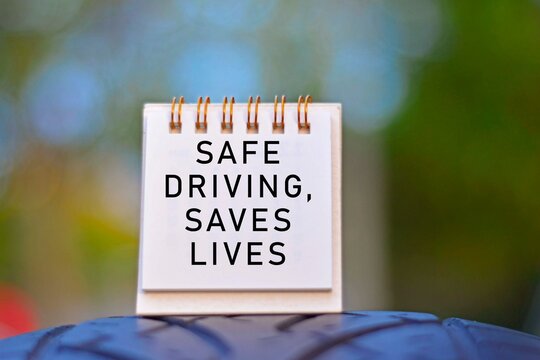 Text Written On A Notepad With Blurred Green Background. Road Traffic Concept