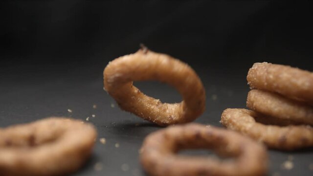 Onion rings close up slow motion studio, tasty fast food
