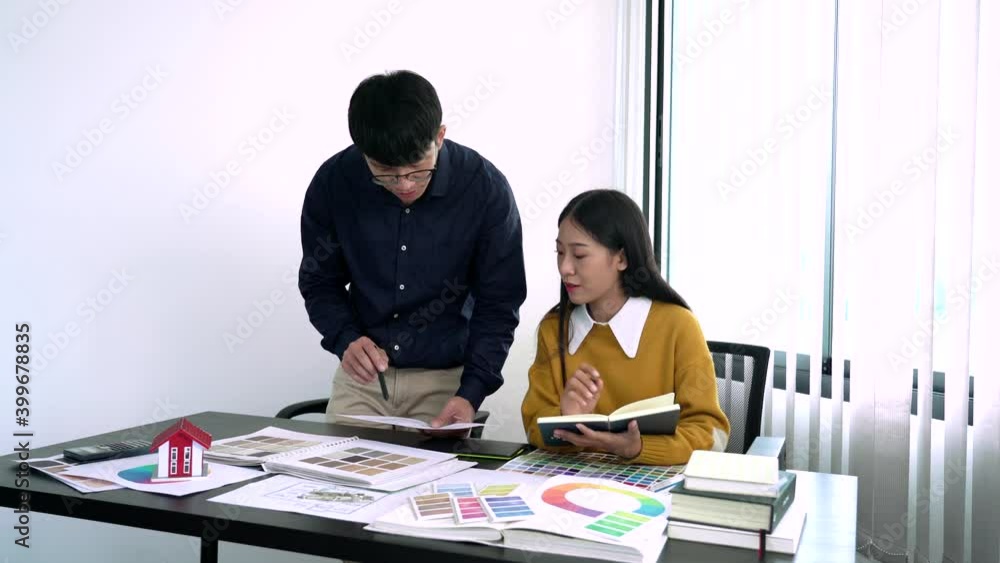 Poster team designer working graphic with color chart on new project with work tools and equipment at workp