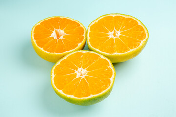 front view fresh tangerine slices on light-blue background photo color orange citrus fruit