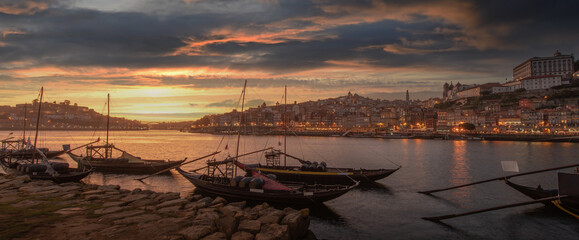 Panoramic of Porto cityscape in sunset with river on the front and wine carrier ship in  foreground and city of Porto in background, Portugal - 399681464