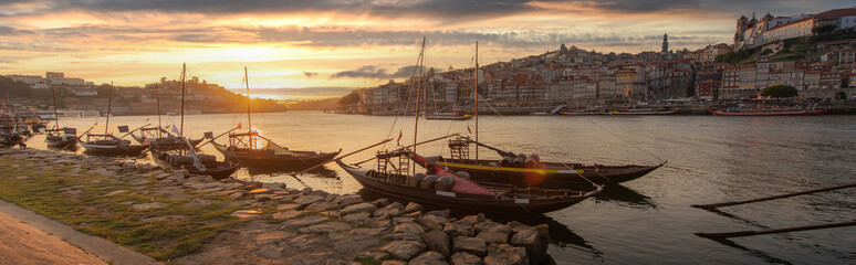 Panoramic of Porto cityscape in sunset with river on the front and wine carrier ship in  foreground and city of Porto in background, Portugal - 399681487