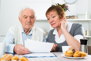 Aged family struggling to pay utility bills and rent for their apartment