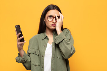 young latin woman feeling bored, frustrated and sleepy after a tiresome, dull and tedious task,...
