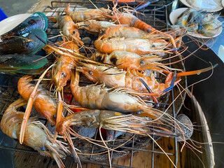 Shrimps and shells on a Thai BBQ grill