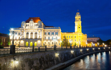 Fototapeta na wymiar Oradea City Hall and quay in night lights, Romania.
