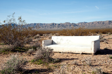 Dumped white couch in the middle of the desert