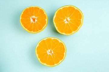 top view fresh tangerine slices lined on light-blue background photo color fruit orange citrus