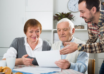 Elderly couple and social department employee complete questionnaire