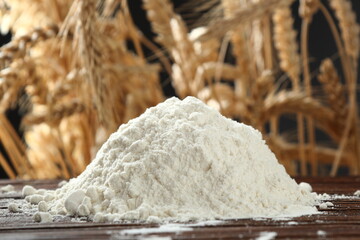 Pile of flour at wheat ears background